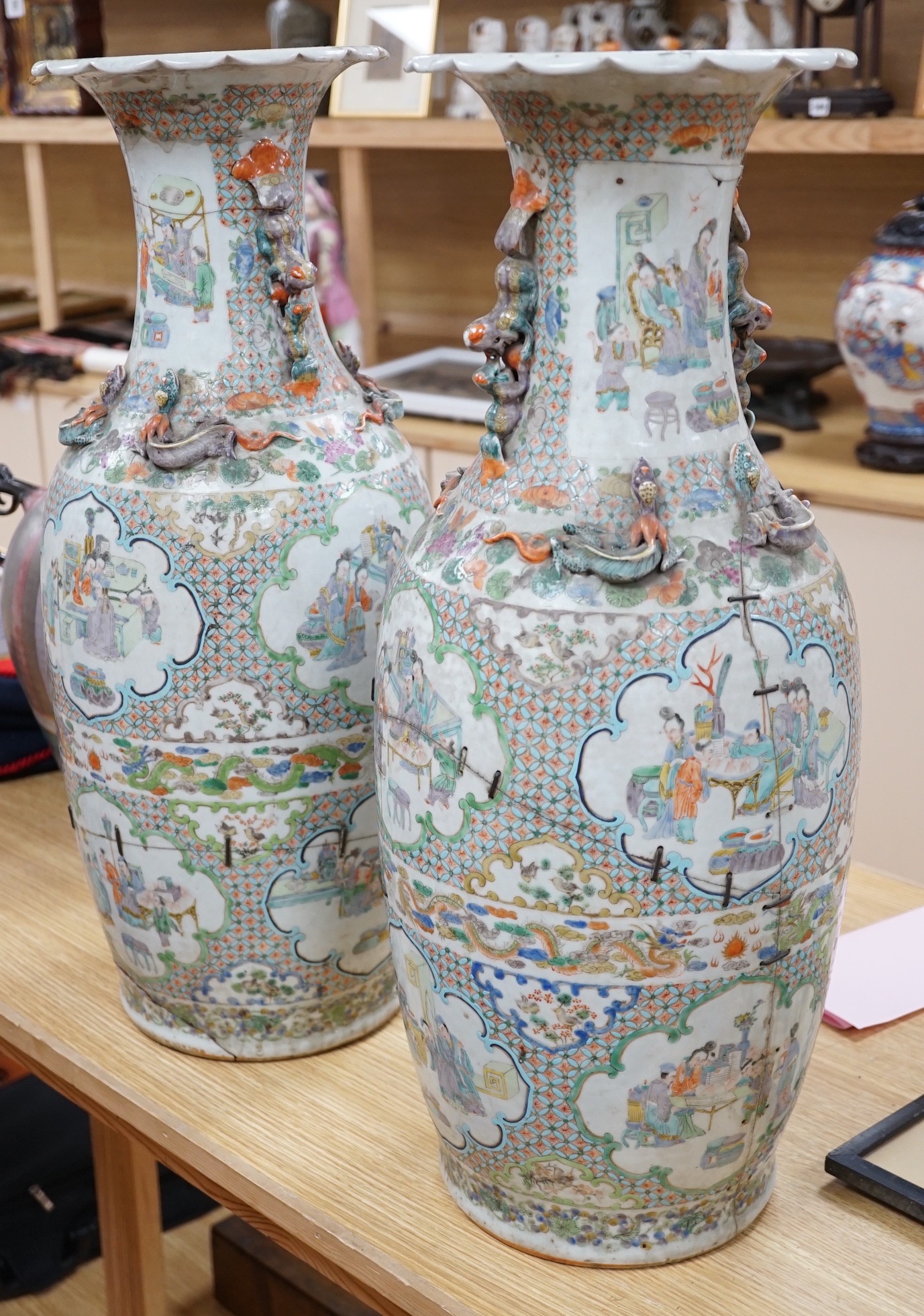 A large pair of Chinese export famille verte dragon vases (in need of restoration), 63cms high